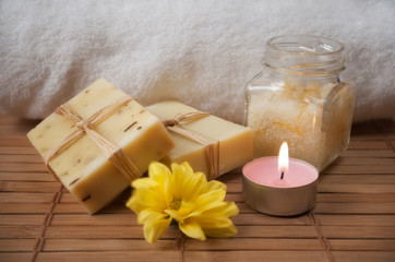 Fototapeta na wymiar Peeling Cream, Flower, Candle and Natural Soap