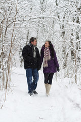 Young couple walking in winter park