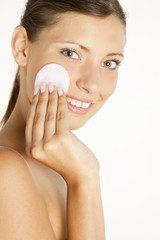 portrait of young woman with cotton pad