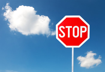 Stop sign for traffic against blue sky
