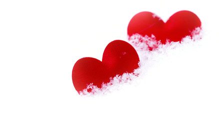 Red hearts on snow