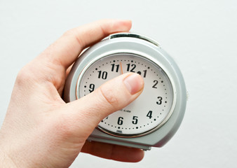 Hand holding alarm clock