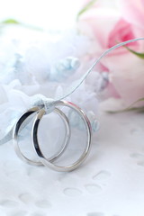 Pink rose and wedding rings
