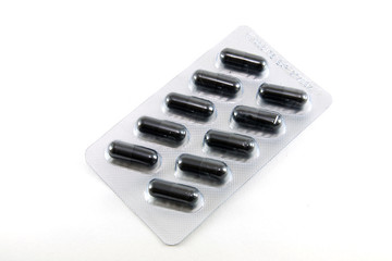 black capsule medicine in package