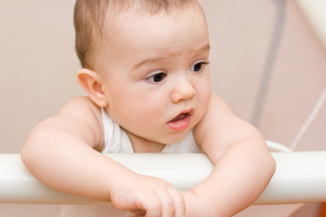 Cute caucasian baby in manege