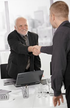 Senior executive shaking hands with businessman