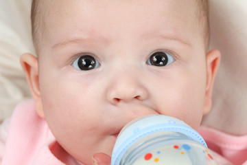 Feeding four month old baby girl