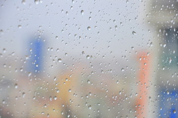 rain drops on a window pane, buildings on background