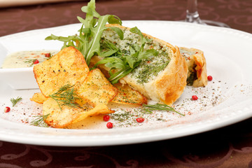 fish pie with sauce and potato chips