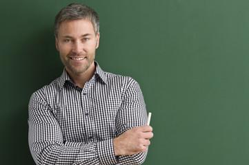 Happy Teacher at the blackboard.