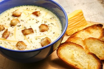 Cheese soup with toasts in blue pottery