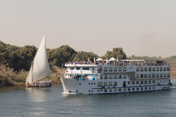 Cruise ship and felucca sailboat on the Nile