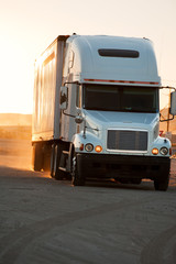 Tractor-trailer in sunset near American interstate I-40