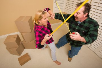 Couple Having Fun Sword Fight with Tape Measures