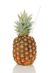 A pineapple with a straw in it