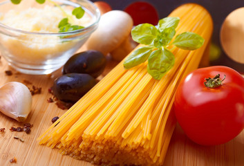 Composition of pasta, tomato, cheese, olive and garlic