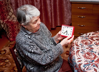 elderly woman in  a room with the alarm clock