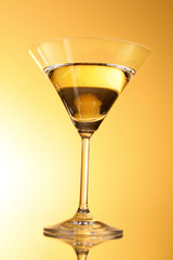 Martini glass on yellow background