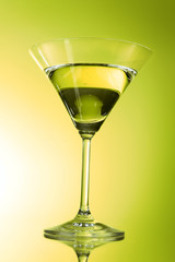Martini glass on green background
