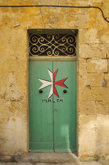 Maltese Cross painted on a doorway.