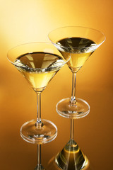 Two martini glasses on yellow background