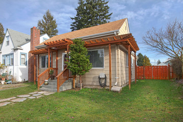 Exterior photo of small beige house