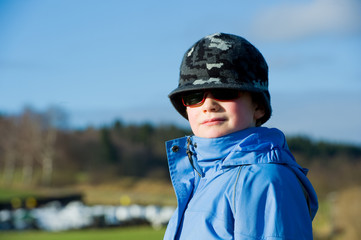 cool boy with sunglasses and cap