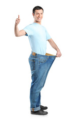 Full length portrait of a weight loss male with thumb up