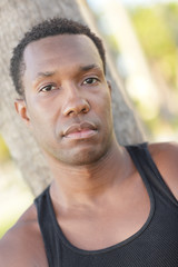 Fototapeta premium Handsome black man by a tree