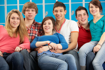 Obraz premium Teenage Students Relaxing By Lockers In School