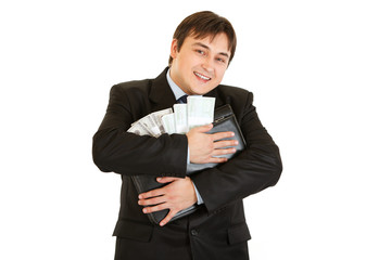 Successful businessman hugging briefcase with money in hands