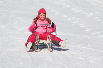 Fototapeta na wymiar girl on the sled