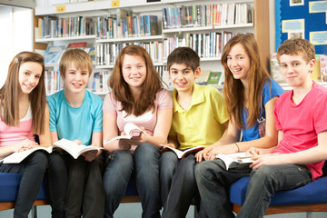 Fototapeta na wymiar Teenage Students In Library Reading Books