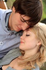 Young cheerful smiling couple in the park