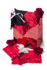 Shopping bags lingerie and flowers isolated