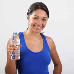 Fitness girl enjoys water after a work out