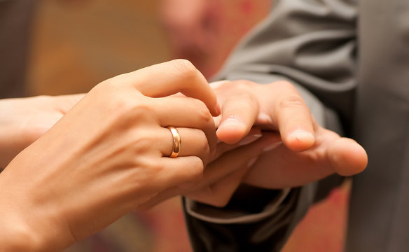 hand of a man put on a wedding ring