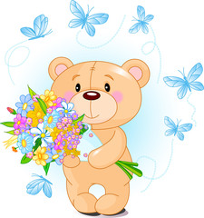 Fototapeta na wymiar Blue Teddy Bear with flowers