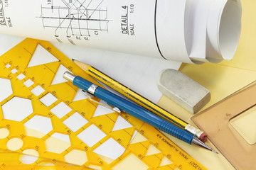 Rolls of architectural blueprints on a drawing table