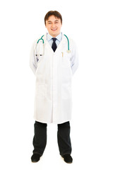 Smiling doctor in uniform with stethoscope isolated on white.