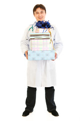 Smiling medical doctor holding presents in hands