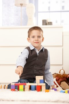 Cute kid proud of building toys