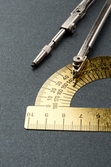 Pair of compasses and protractor isolated on white