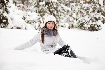 Fototapeta na wymiar Happy girl sitting on snow