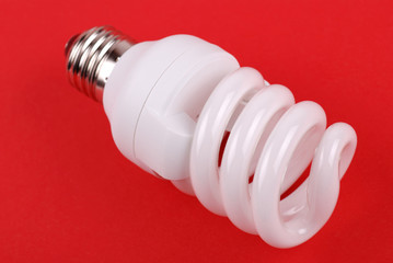 energy saving bulb on red