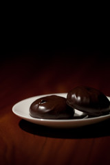 Chocolate zephyr sweets on a saucer
