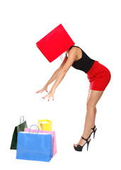 Funny  shopaholic woman put her head in a shopping bag
