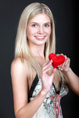 Pretty young woman with red heart