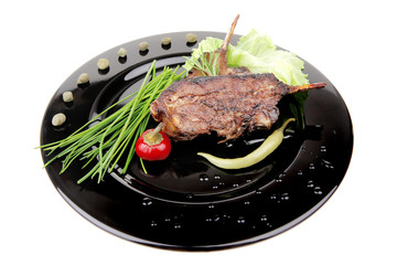 served entree: ribs on plate with hot peppers