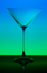 conceptually illuminated martini glass on gradient background
